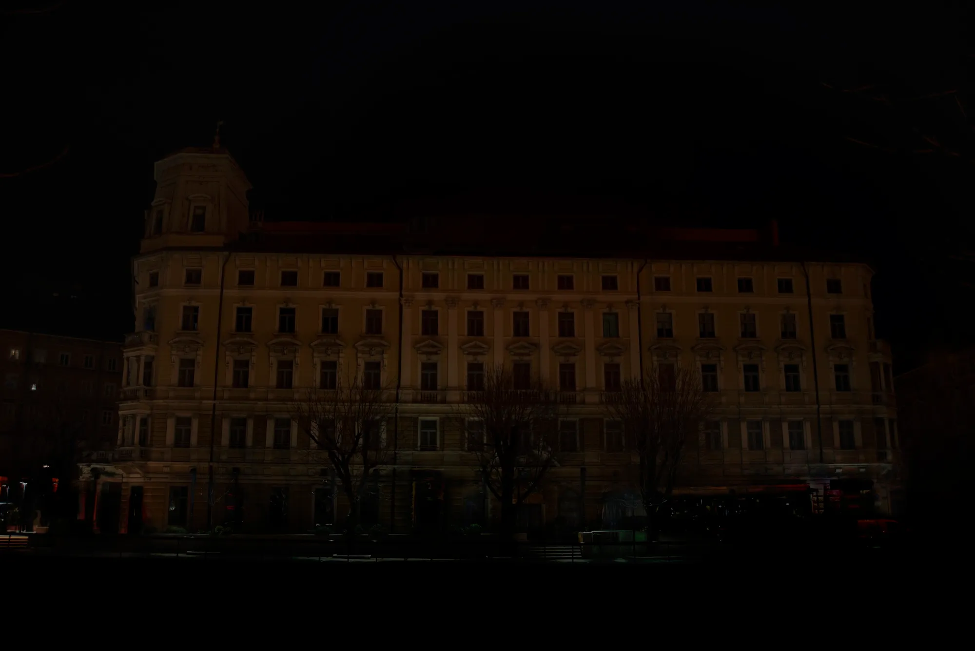 A dimly lit night photograph of the Hotel Continental building facade.