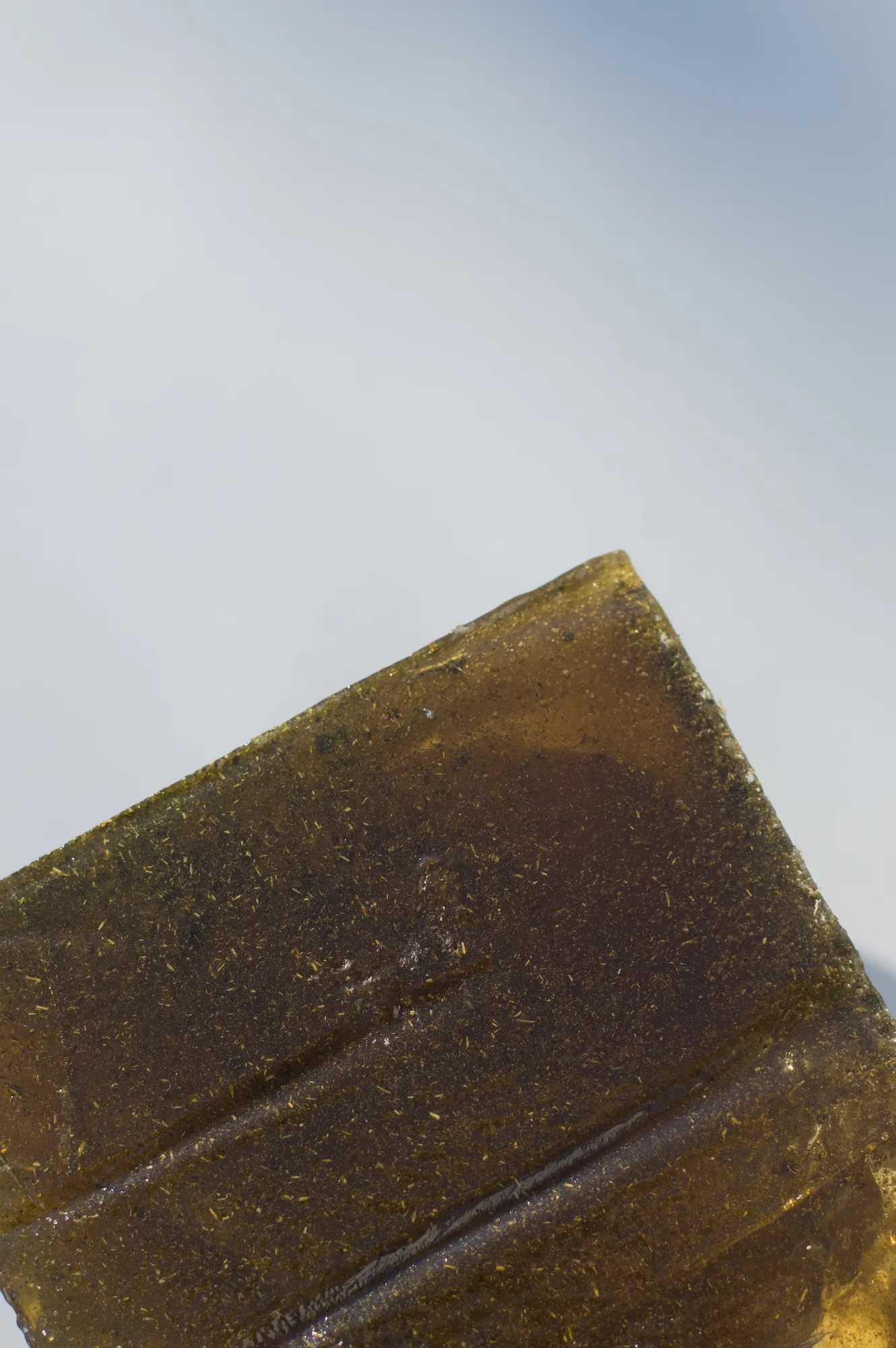 Overhead close-up of the isomalt cube's top corner and surface texture.