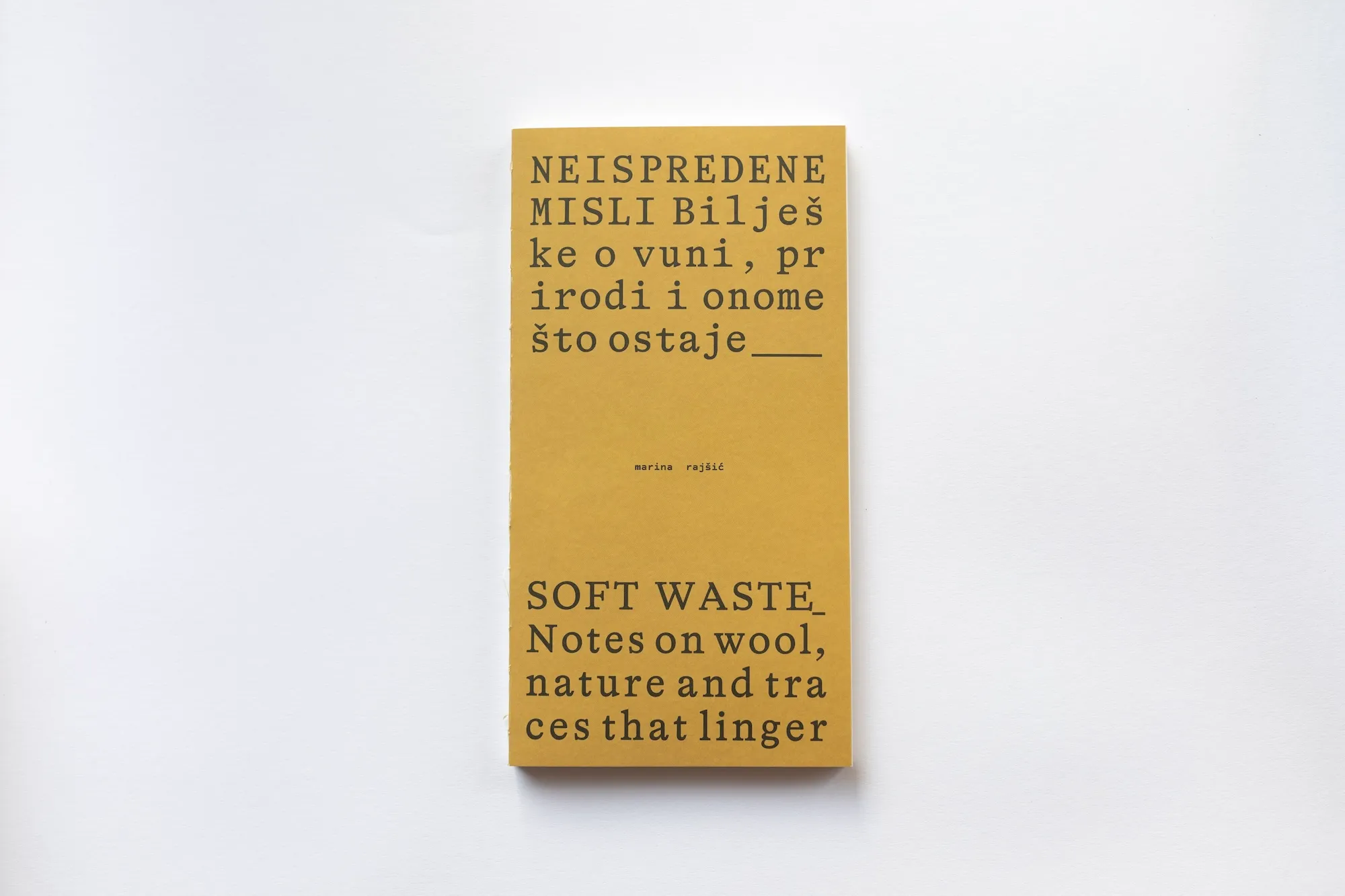 The mustard-yellow cover of the book "Soft waste: Notes on wool, nature and traces that linger" by Marina Rajšić.