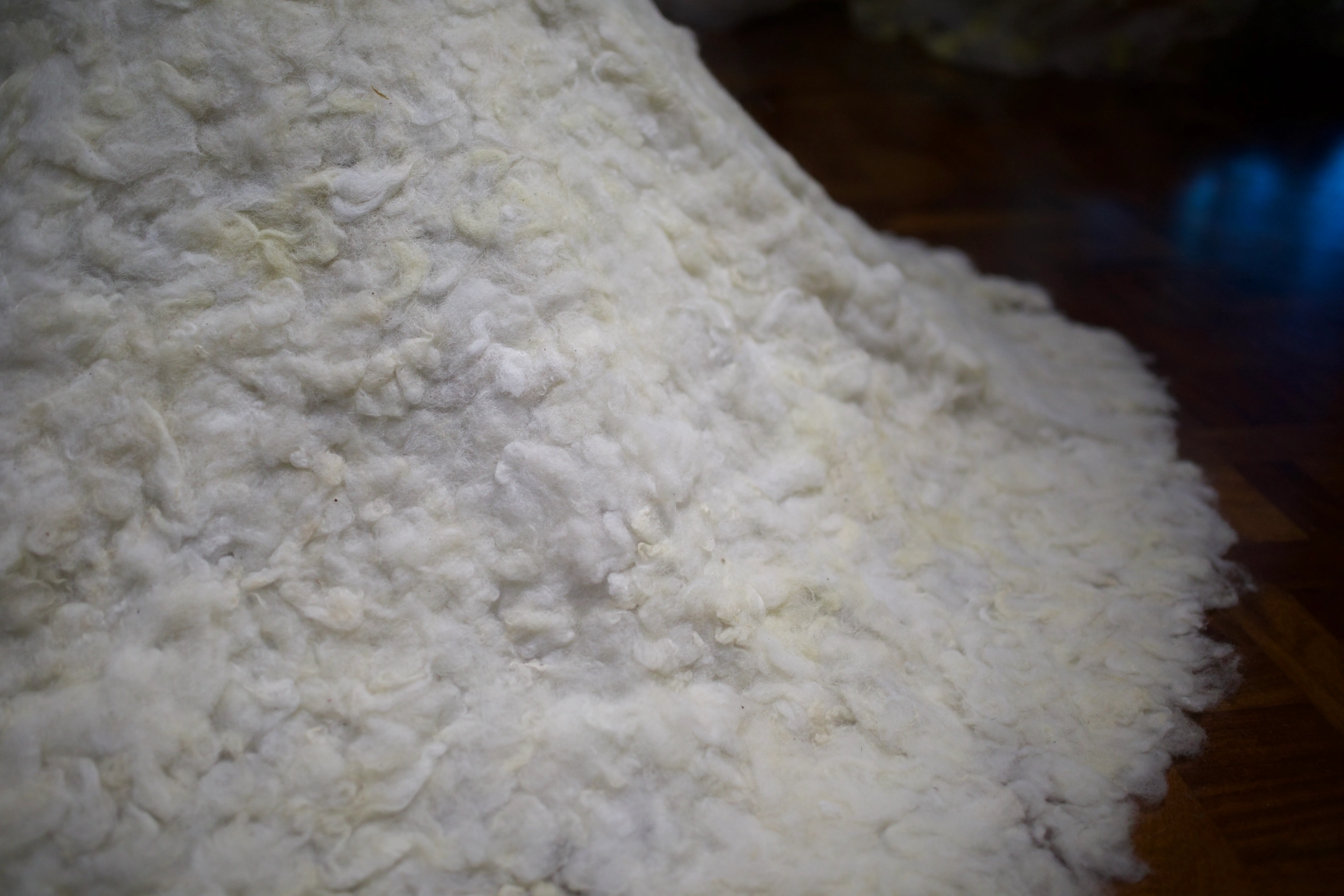 Extreme close-up of the textured surface of the white felted wool.